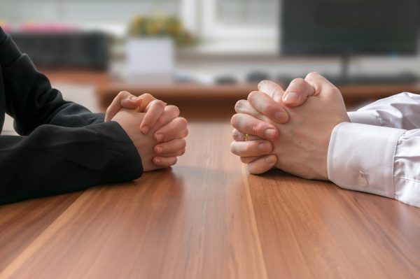 Interview or dialogue between politicians. Negotiation of two statesman with clasped hands in office.