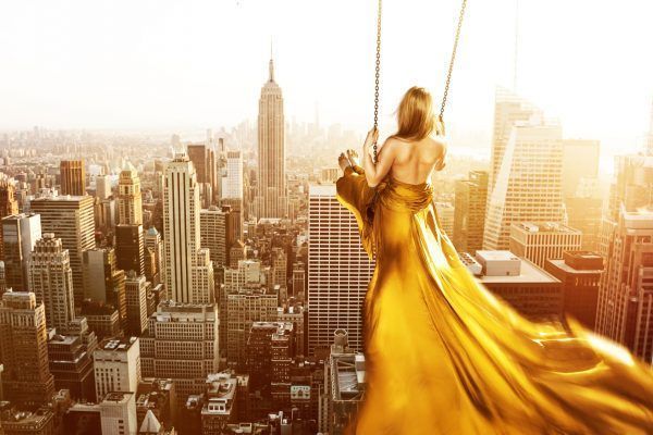 Woman on a swing above New York City