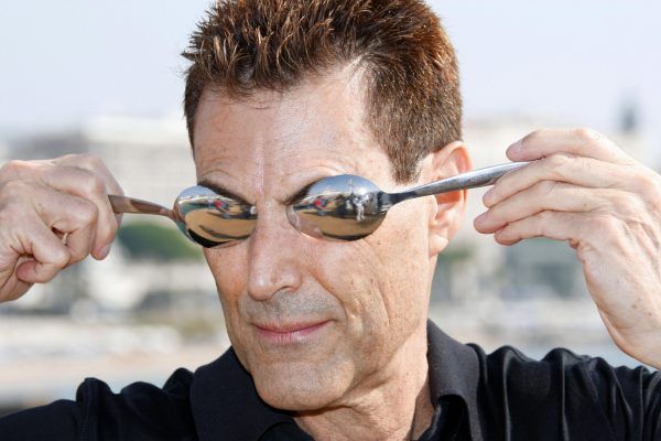 Israeli-British hypnotizer Uri Geller poses during the photocall of "The Successor Show" at the 24th edition of the five-day MIPCOM, on October 14, 2008 in Cannes, southern France. Thousands of TV content buyers are due to attend this year's international audiovisual entertainment trade show. AFP PHOTO VALERY HACHE (Photo credit should read VALERY HACHE/AFP/Getty Images)