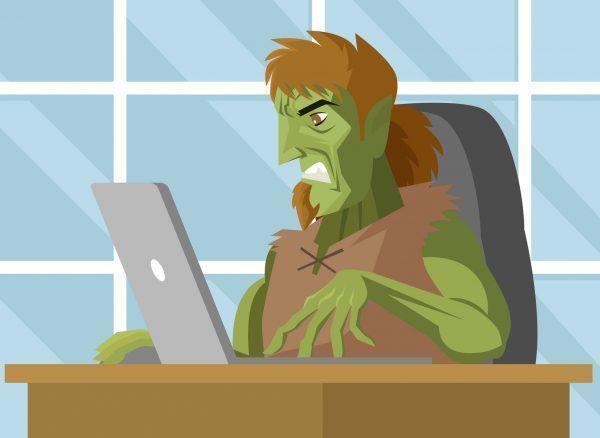 angry evil troll using a computer