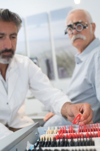 Optician testing sight of senior citizen