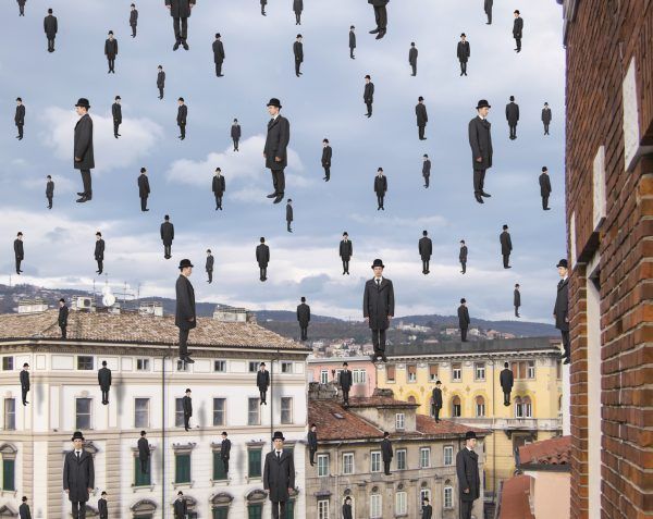 businessmen floating in the sky over european city, magritte style