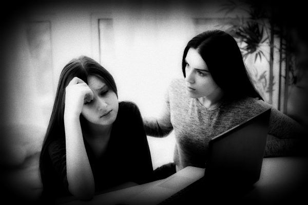 Scared mother arguing daughter over online activity. Cyber bullying or blue whale game concept