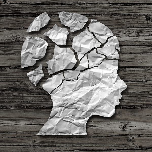 Child abuse concept and physical or emotional damage in children as a victim of violence or sexual assault as a crumpled paper on rustic wood shaped as the head of a young neglected person as a psychology metaphor in a 3D illustration style.