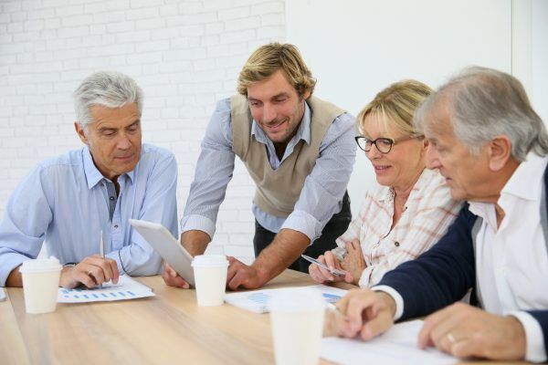 Business instructor with group of senior people