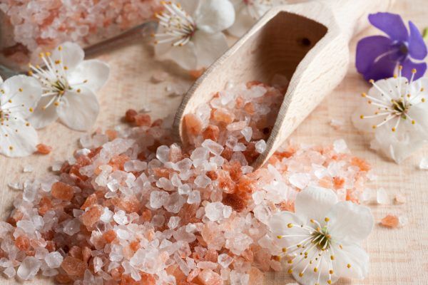 Pink Himalayan sea salt on a wooden background