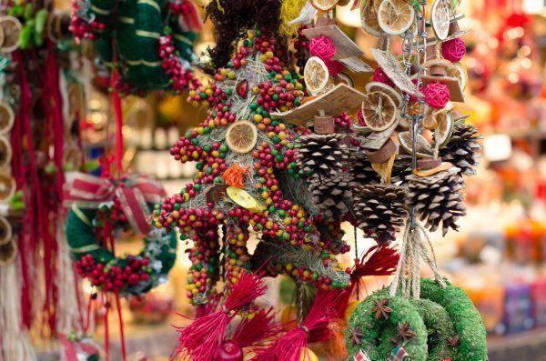 Christmas market in details. Handmade Christmas decoration from natural materials - tangerine, leaves, cinnamon, seeds, cones