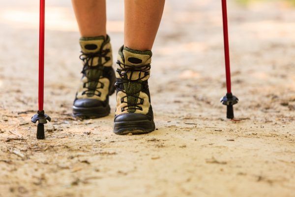 Outdoor survival sport leisure relax concept. Person travelling on dirt road. Young hiker during trip.