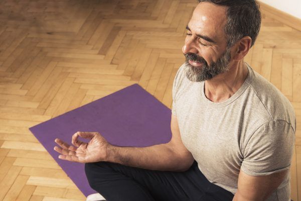 Senior mature man practicing yoga
